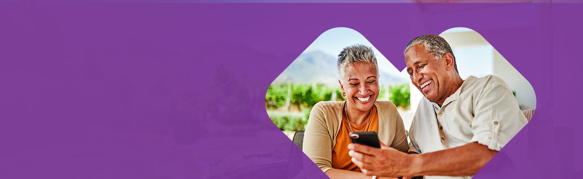 Smiling retirees looking at phone
